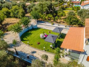 an overhead view of a garden with a swimming pool at Afroditi Holiday Home - Blue Apartment in Svoronata