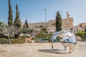 une sculpture du globe dans un parc avec un bâtiment dans l'établissement Unique View - 2 BR & 2 BTH - Monbaz streetM, à Jérusalem