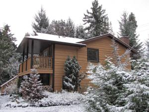 a log cabin in the woods with snow at Shawnigan Lake Bed and Breakfast in Shawnigan Lake