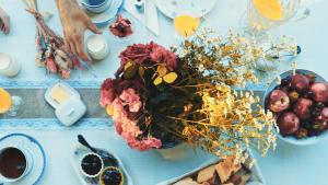 a blue table with a bunch of flowers and fruit at Domaine De La Mouthe in Saint-Rémy +20 photos