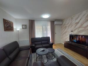 a living room with a couch and a fish tank at ELITE Park Lake in Tuzla