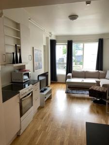 a living room with a couch and a table at Parken Terrasse Apartment Hotel in Kopervik