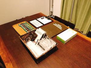 a table with a book and books on it at OAK Yasaka / Vacation STAY 478 in Osaka