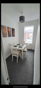 a dining room with a table and two chairs at Bedlington apartment in Bedlington