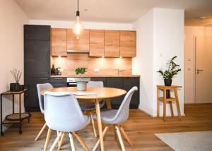 a kitchen and dining room with a wooden table and chairs at Apartment K13 in Bad Wiessee