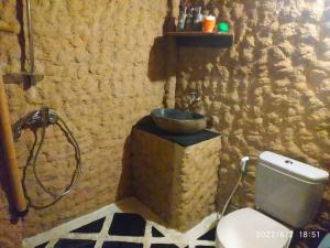 a bathroom with a shower and a toilet with a sink at Kampung Meno Bungalows in Gili Meno