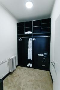 a room with a closet with black cabinets at Hotel Srem in Sremska Mitrovica