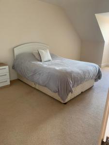 a bedroom with a bed with a white bed frame at Captivating 4-Bed House in west Wales in Pencader