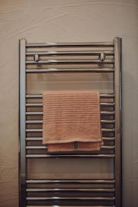 a towel hanging on a towel rack in a bathroom at Lizzie's Cottage in Drumaroad