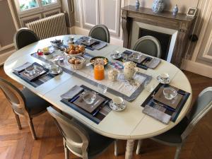 a dining room table with food on top of it at L'Avre des Joncherets - proche center parc les Bois Francs in Saint-Lubin-des-Joncherets