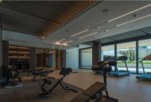 a gym with treadmills and exercise equipment in a room at Sky Tower in Limassol