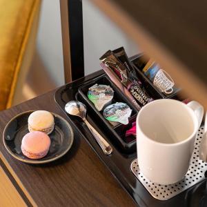 a tray with two biscuits and a cup of coffee at La maison py in Vergisson