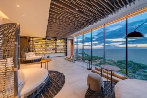 a living room with a view of the ocean at Unique 1-BR w/Seaview Balcony and Onsen in Pattaya in Pattaya South