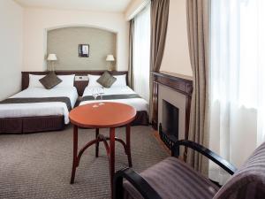 Postel nebo postele na pokoji v ubytování Hotel Francs