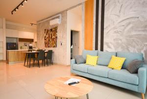 a living room with a blue couch and a table at Twin Galaxy Suite by Nest Home in Johor Bahru