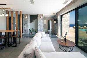 A seating area at Seafront elegant villas, with infinity pools & devine views!
