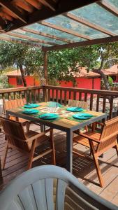 een houten tafel en stoelen op een terras bij Chalé em Barreirinhas 599,00 6 pessoas in Itaqui