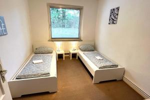 a room with two beds and a window at Apartment in Celle for Business Traveler in Celle +4 photos