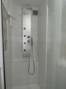 een badkamer met een douche en een glazen deur bij Terrace in Monti44a in Rome