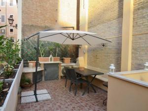 a patio with a table and an umbrella at Terrace in Monti44a in Rome