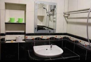 a black and white bathroom with a sink and a mirror at Crown Imperial Court Apartment (Madam Ng)1 in Cameron Highlands +16 photos