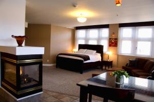 a living room with a bed and a fireplace at Century Casino & Hotel Cripple Creek in Cripple Creek +46 photos