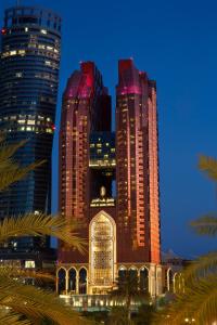 a group of tall buildings in a city at night at Bab Al Qasr Hotel in Abu Dhabi