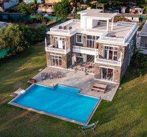 an aerial view of a house with a swimming pool at ama Stays and Trails Casa Kenzo, Kashid in Mumbai