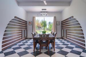 a dining room with a table and chairs at ama Stays and Trails Casa Kenzo, Kashid in Mumbai