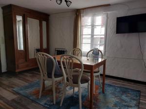 a dining room with a wooden table and chairs at ReSt Inn Monschau in Monschau