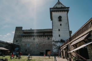a group of people standing in front of a castle at Narva Castle Rooms in Narva