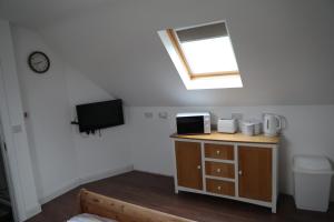 a bathroom with a skylight and a toilet and a sink at Cosy Loft situated on shores of Lough Neagh 