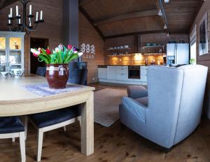 a kitchen and dining room with a table and chairs at Maybua by May's in Reine