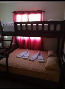 a bunk bed with two pairs of slippers on it at Apartamentos ipap luperon in Puerto de Luperon