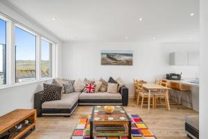 a living room with a couch and a table at 5 The Dunes in Perranporth