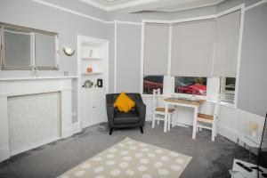 a living room with a chair and a table at Bonhill Getaway in Dumbarton