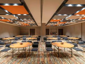 a large room with tables and chairs in it at ibis Bengaluru Hebbal - An Accor Brand in Bangalore