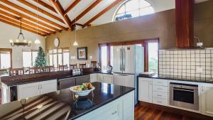 a large kitchen with a bowl of fruit on a counter at Knysna Pearl View Guest House in Knysna