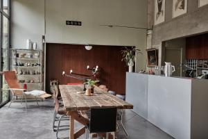 - une salle à manger avec une table et des chaises en bois dans l'établissement LA PORTE ROUGE RBX, à Roubaix