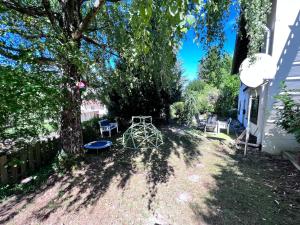 a backyard with a table and chairs under a tree at Julia in Gernsbach