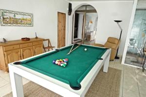 a living room with a pool table with balls on it at Las Gaviotas in L'Ampolla