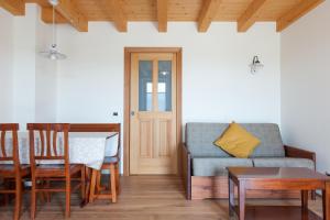 a living room with a couch and a table at Hotel & Restaurant Pahor in Doberdò del Lago
