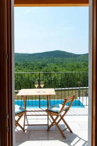 a patio with a table and chairs and a pool at Hotel & Restaurant Pahor in Doberdò del Lago