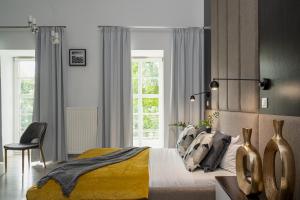 um quarto com uma cama, uma cadeira e uma janela em Apartamenty na Kazamatach 24 Old Town Wroclaw em Breslávia