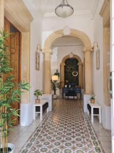 a hallway with an archway and a living room at Hostel On in Sliema