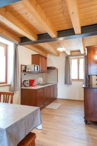 a large kitchen with wooden floors and wooden ceilings at Hotel & Restaurant Pahor in Doberdò del Lago