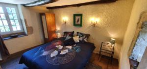 a living room with a blue couch in a room at Le Fier Paon in Pierrefaites