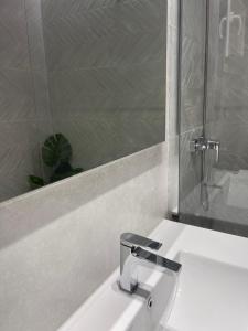 a bathroom with a white sink and a mirror at Lovely Capuchinos in Málaga