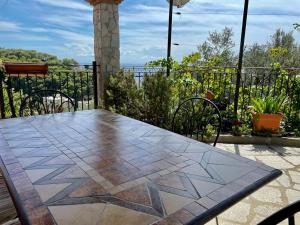 a table and chairs on a patio with a view of the ocean at Le Chiazze in Spotorno