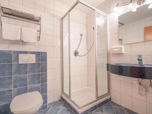 a bathroom with a shower and a toilet and a sink at Attractive Apartment in Stubaital with Ski Boot Heaters in Neustift im Stubaital